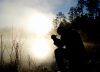 silhouette of kneeling man